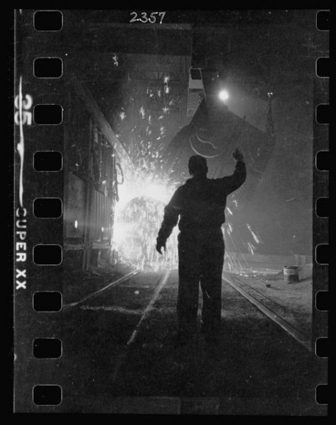 11-15.-Steel-worker-in-mill-as-molten-steel-spills-from-vat-in-Chicago-Illinois-2-475x600