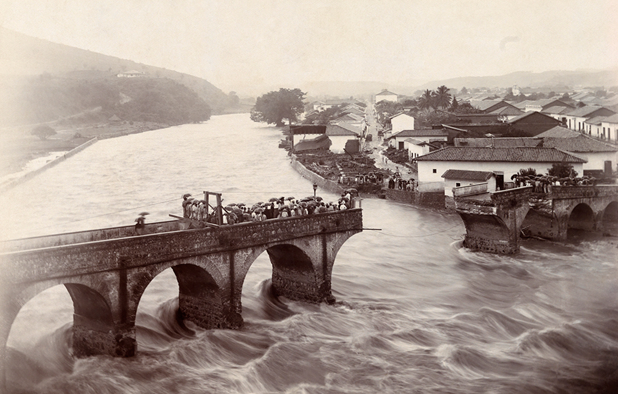 A rush of water in freshet season collapses Tegucigalpa’s arched bridge in Honduras, August 1916.Photograph by F. J. Youngblood, National Geographic