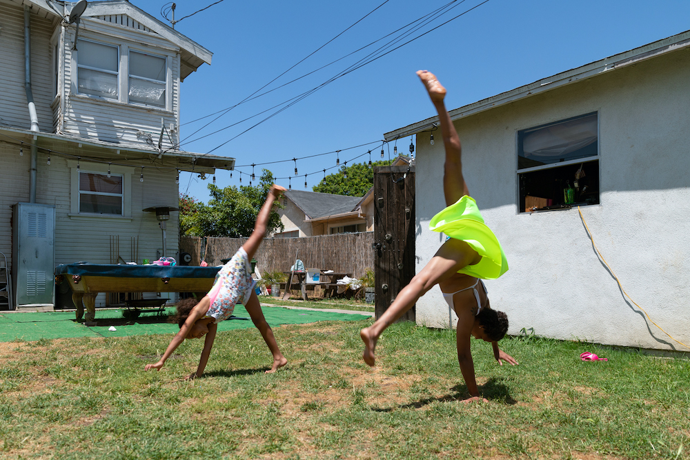  Rita and Mary Jane Harris practice cartwheels in the backyard. May 8, 2020. Los Angeles, CA.