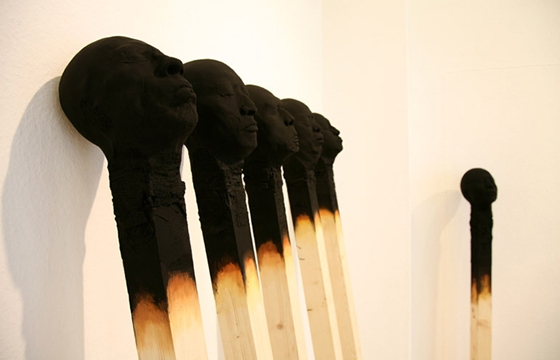 Giant Charred Matchstick Faces by Wolfgang Stiller