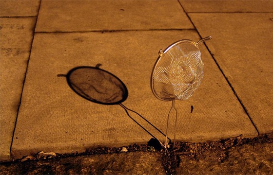 Strainer Shadow Art by Isaac Cordal