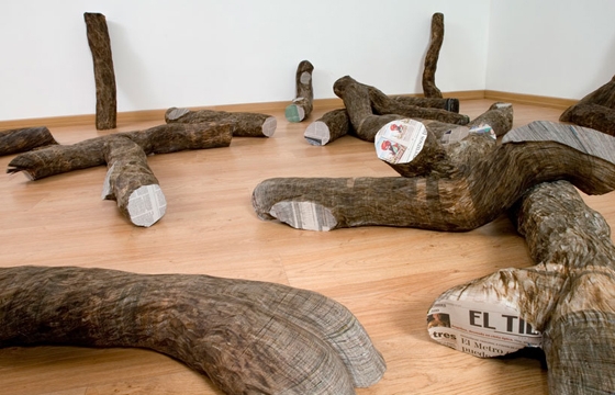 Tree Trunks Made from Stacked Newspapers