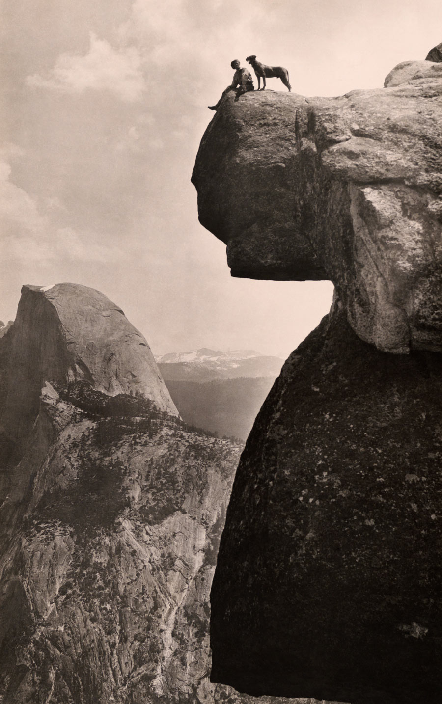 A man and his dog on the Overhanging Rock in Yosemite National Park, May 1924. Photograph by Educational-Bruce Photograph
