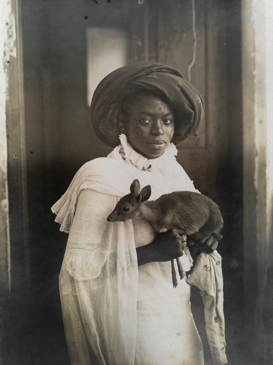 A young Kenyan woman holds her pet deer in Mombassa, March 1909. Photograph by Underwood and Underwood