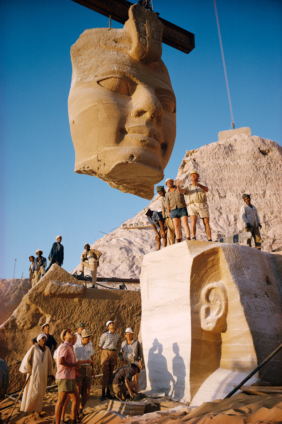Cranes lift the face of a statue from the Abu Simbel Temples in Egypt, May 1966. Photograph by Georg Gerster, National Geographic
