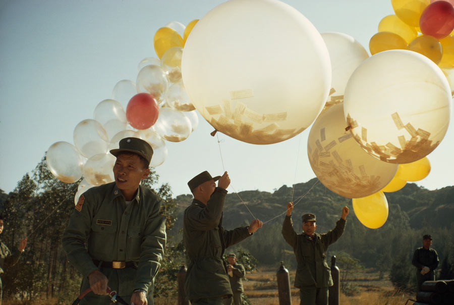 To spread political views, soldiers release balloons holding leaflets in Taiwan, January 1969. Photograph by Frank and Helen Schreider, National Geographic