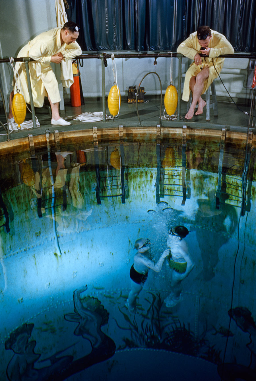 A submarine trainee and instructor rise to the surface of a training tank in New London, Connecticut, November 1952. Photograph by David Boyer, National Geographic