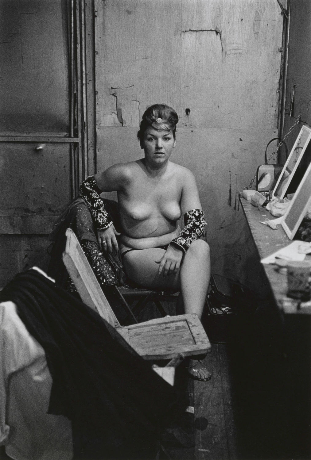 Stripper with bare breasts sitting in her dressing room, Atlantic City, N.J. 1961