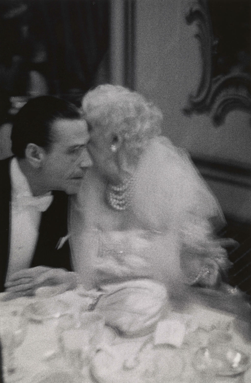Elderly woman whispering to her dinner partner, Grand Opera Ball, N.Y.C. 1959