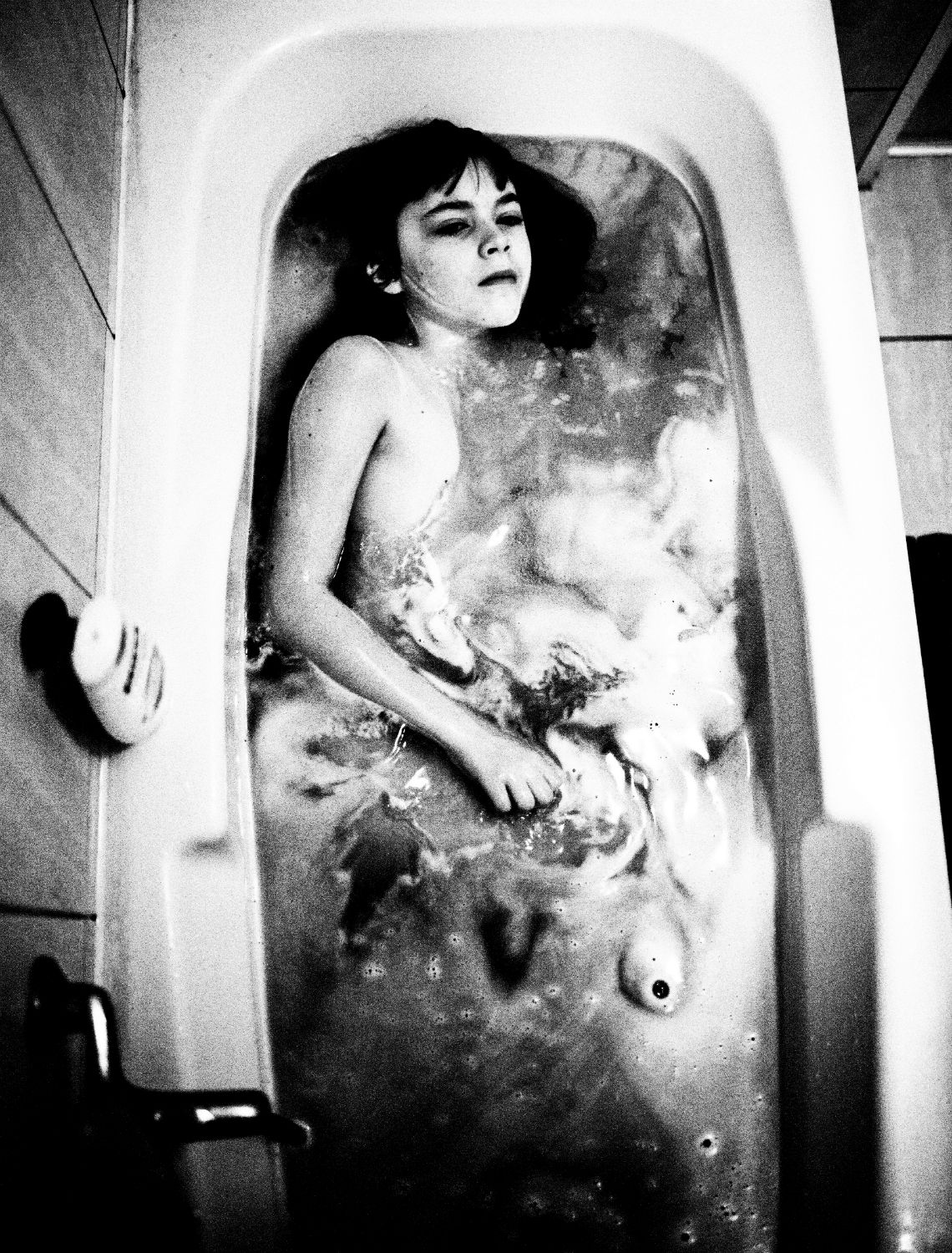 "This is a piece from my long-term project, Pestka. This word, unfortunately, has no direct translation in English, but means something like body, fruit, seed or stone. I watch her grow up, her body balancing on the borderline between innocence and guilt, between unawareness and consciousness. I think she appears as my own younger lookalike, a reflection of myself caught in statu nascendi, the very moment when a stone is transforming into a fruit."