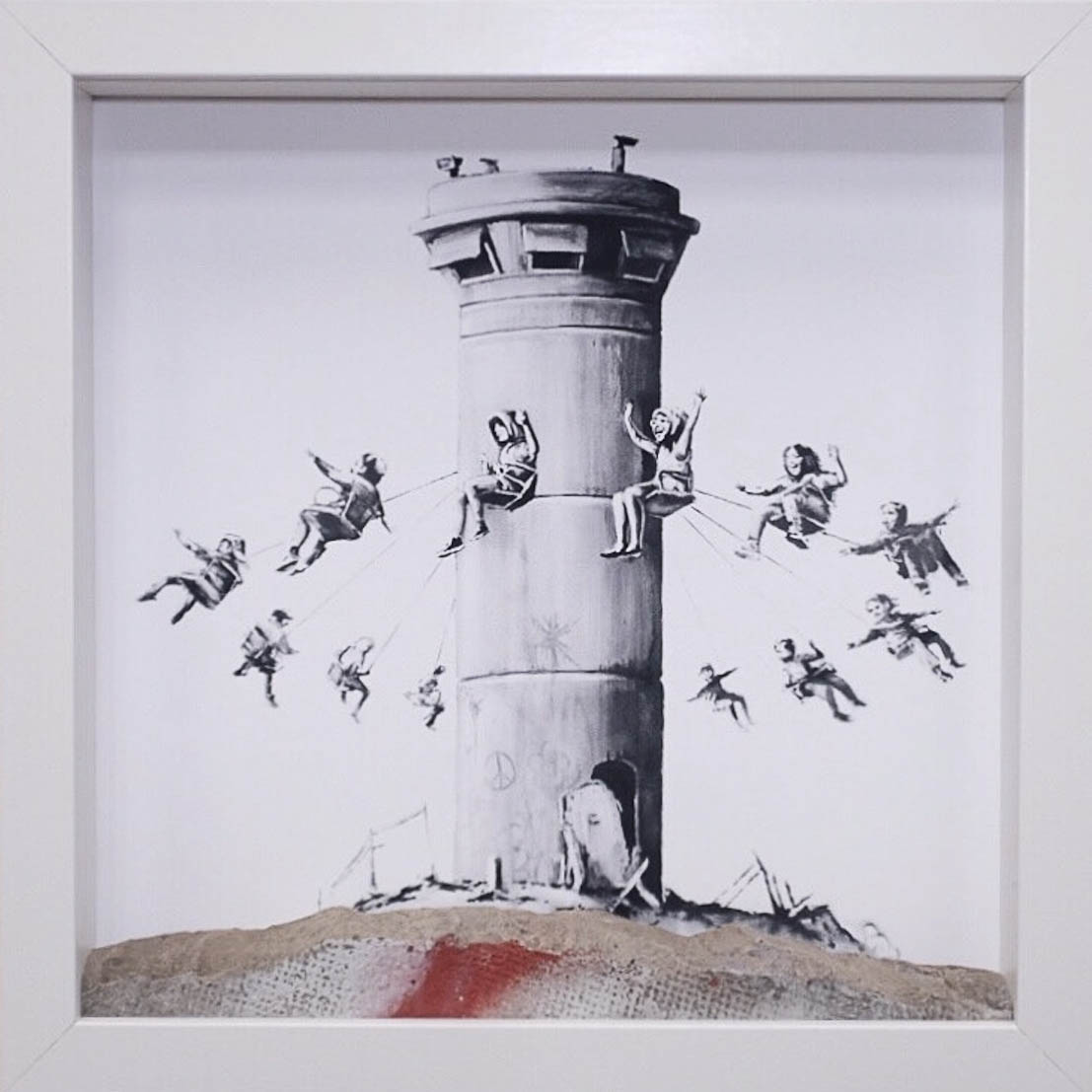 A Banksy art print housed in a cheap Ikea frame with an actual chiseled off piece of wal