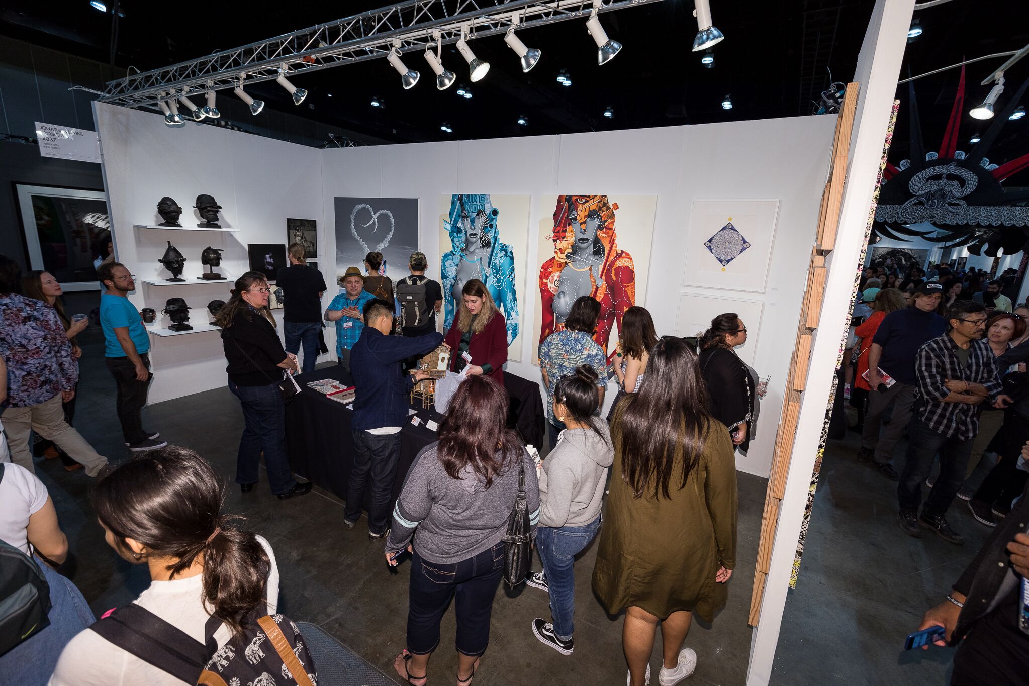 Jonathan Levine Projects Booth featuring some Tristan Eaton paintings and Jonathan Levine himself