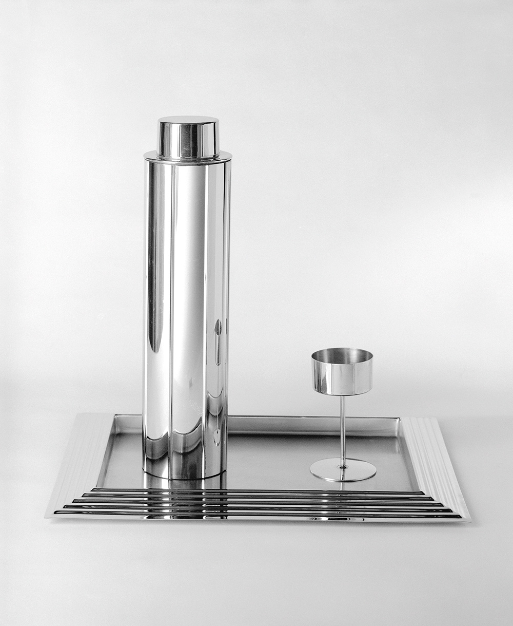 Norman Bel Geddes, "Skyscraper" cocktail shaker, eight glasses, and serving tray, designed 1934, manufactured 1935. chrome-plated metal, 12 3/4 x 3 1/4 x 3 1/4 in. (32.4 x 8.4 x 8.4 cm). Brooklyn Museum, Gift of Paul F. Walker, 83.108.5a-c