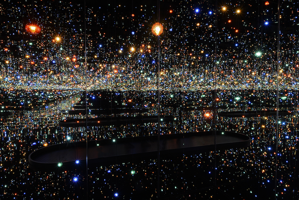Installation view of Infinity Mirrored Room—The Souls of Millions of Light Years Away (2013) at the Hirshhorn Museum and Sculpture Garden, 2017. Yayoi Kusama (Japanese, b. 1929). Wood, metal, glass mirrors, plastic, acrylic panel, rubber, LED lighting system, acrylic balls, and water; 287.6 x 415.3 x 415.3 cm (113 1/4 x 163 1/2 x 163 1/2 in). Courtesy of David Zwirner, New York. © Yayoi Kusama. Photo by Cathy Carver