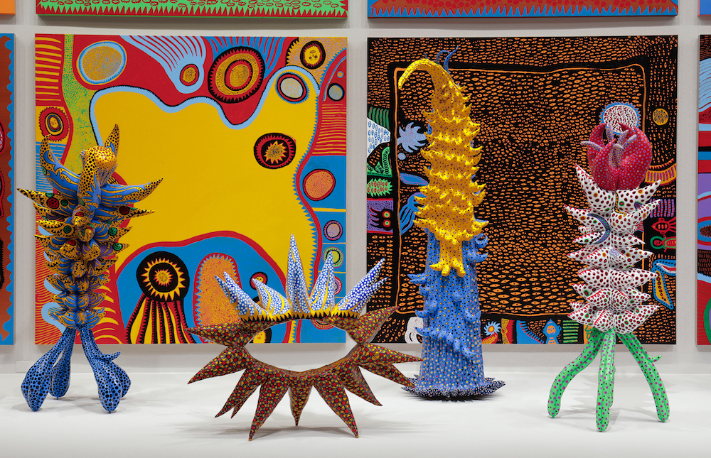 Installation view of Yayoi Kusama: Infinity Mirrors at the Hirshhorn Museum and Sculpture Garden, 2017. Left to right: Living on the Yellow Land (2015); My Adolescence in Bloom (2014); Welcoming the Joyful Season (2014); Surrounded by Heartbeats (2014); Unfolding Buds (2015); Story After Death (2014). Yayoi Kusama (Japanese, b. 1929). © Yayoi Kusama. Photo by Cathy Carver
