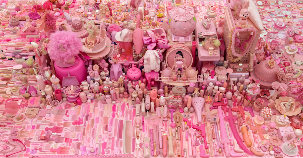 Pink Project Table; Table (detail), 1994-2016, found pink plastic objects and table, 30 in high x 8 ft wide x 14 ft wide, image courtesy of the artist.