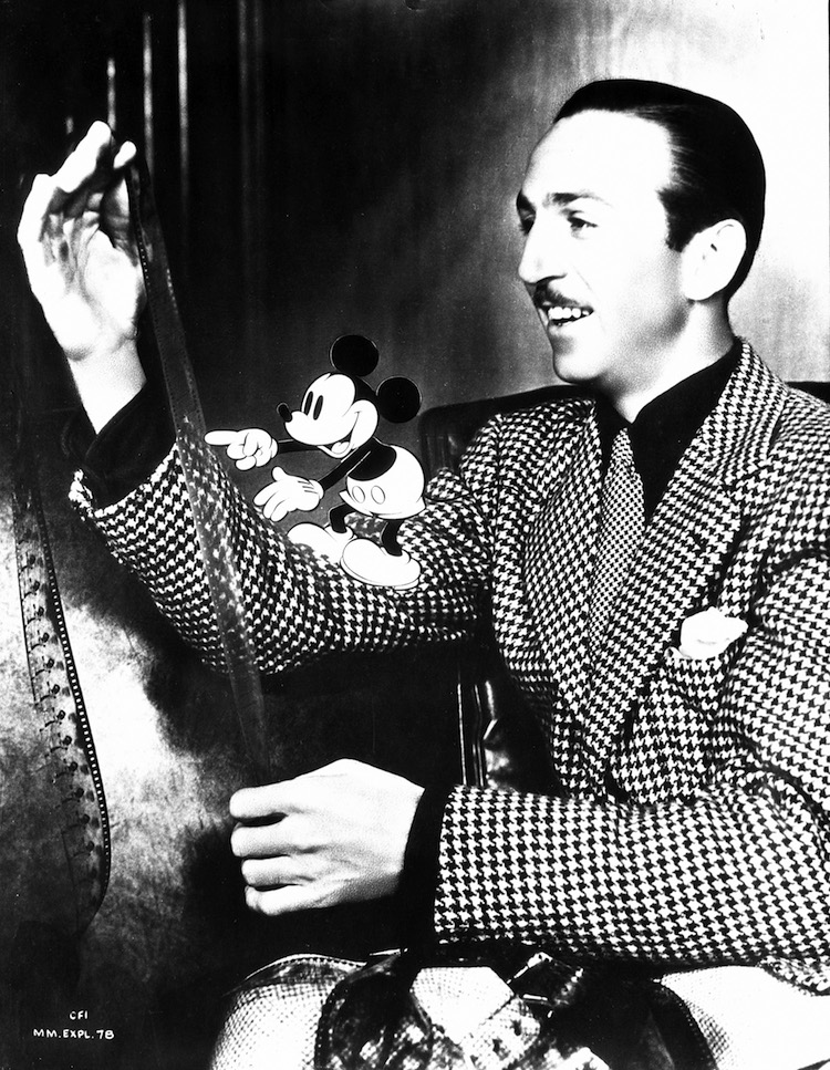 Walt Disney inspecting a filmstrip with an animated Mickey Mouse 1939_Exhibition Graphic_Courtesy of the Walt Disney Archives Photo Library, (c) Disney