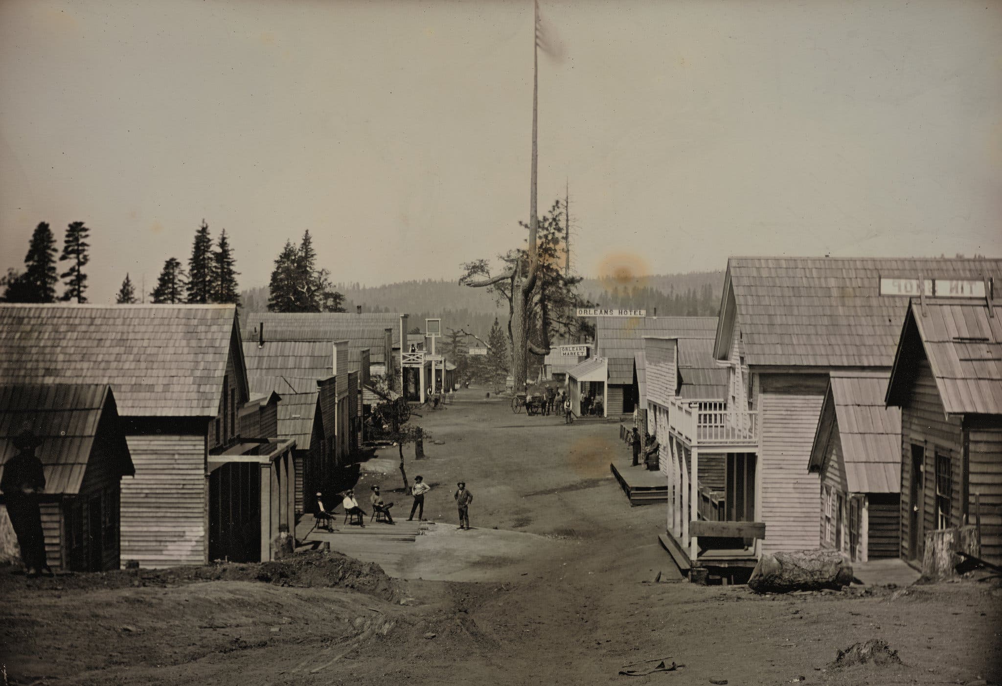 A street in a mining town, where an American flag is raised. Circa 1852. © Canadian Photography Institute