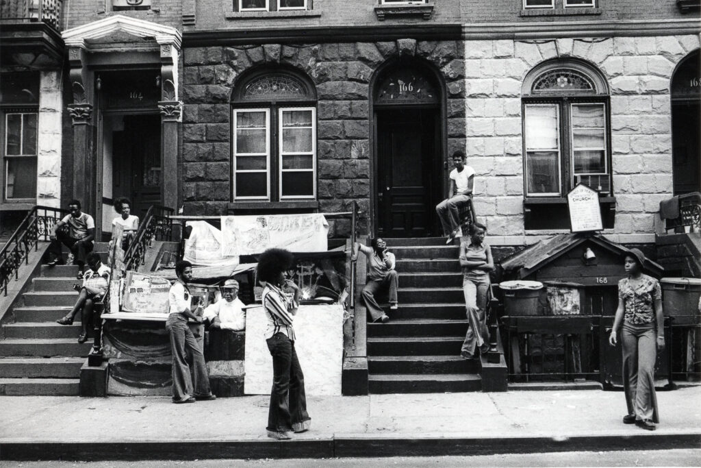 Carrie Mae Weems (American, b. 1953). Harlem Street, 1976–77. Gelatin silver print, 5 5/16 x 8 15/16 inches. © Carrie Mae Weems. Courtesy of the artist and Jack Shainman Gallery, New York.