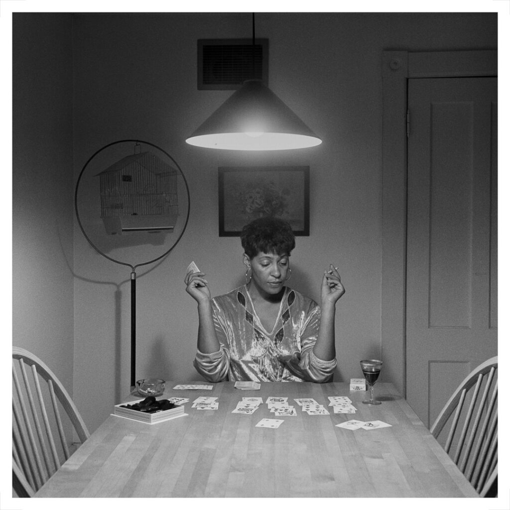 Carrie Mae Weems (American, b. 1953). Untitled (Woman playing solitaire) from The Kitchen Table Series, 1990. Gelatin silver print, 40 x 40 inches. © Carrie Mae Weems. Courtesy of the artist and Jack Shainman Gallery, New York.