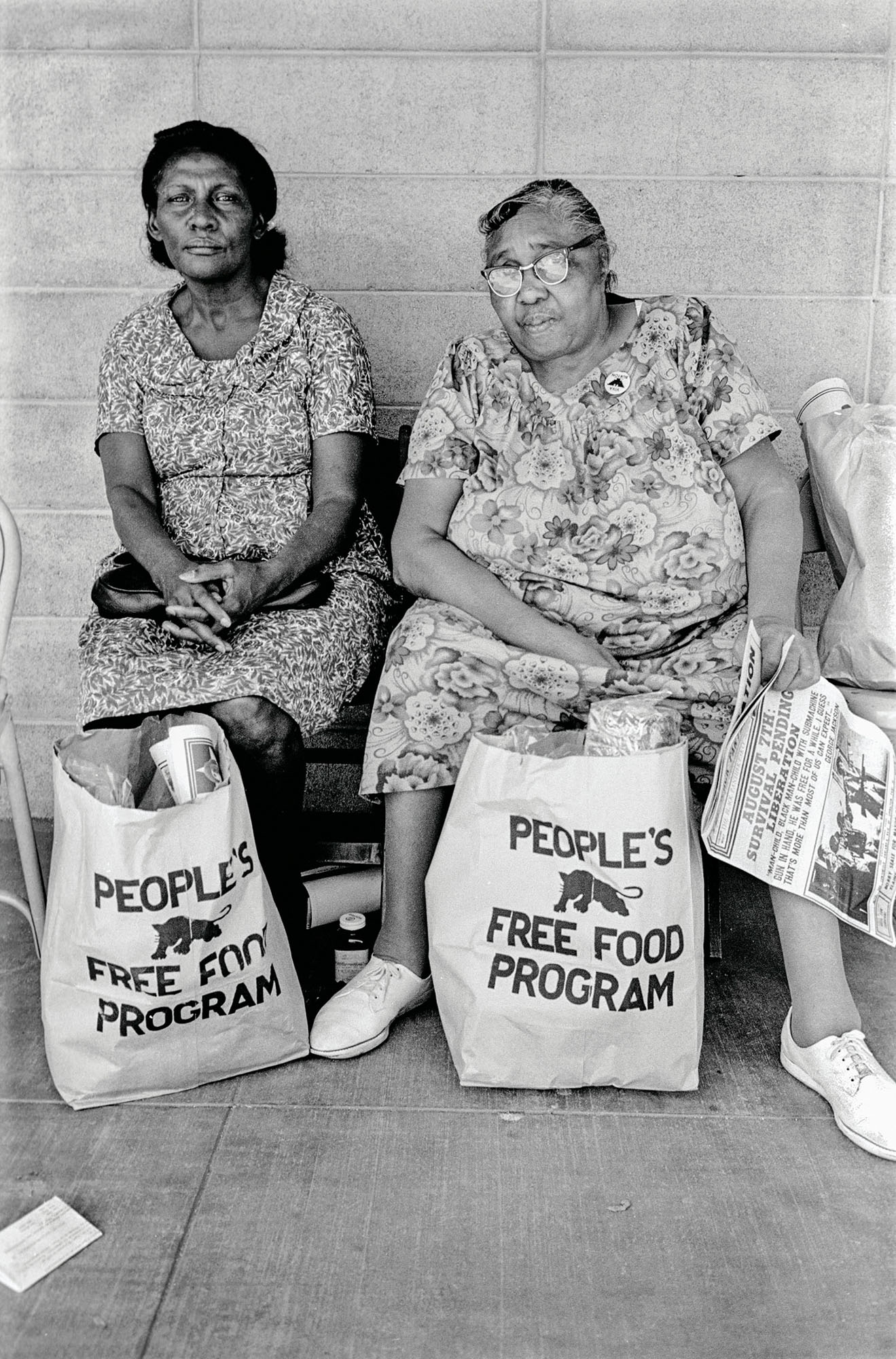 1972 - Palo Alto, California: Two women wi th bags of food at the People