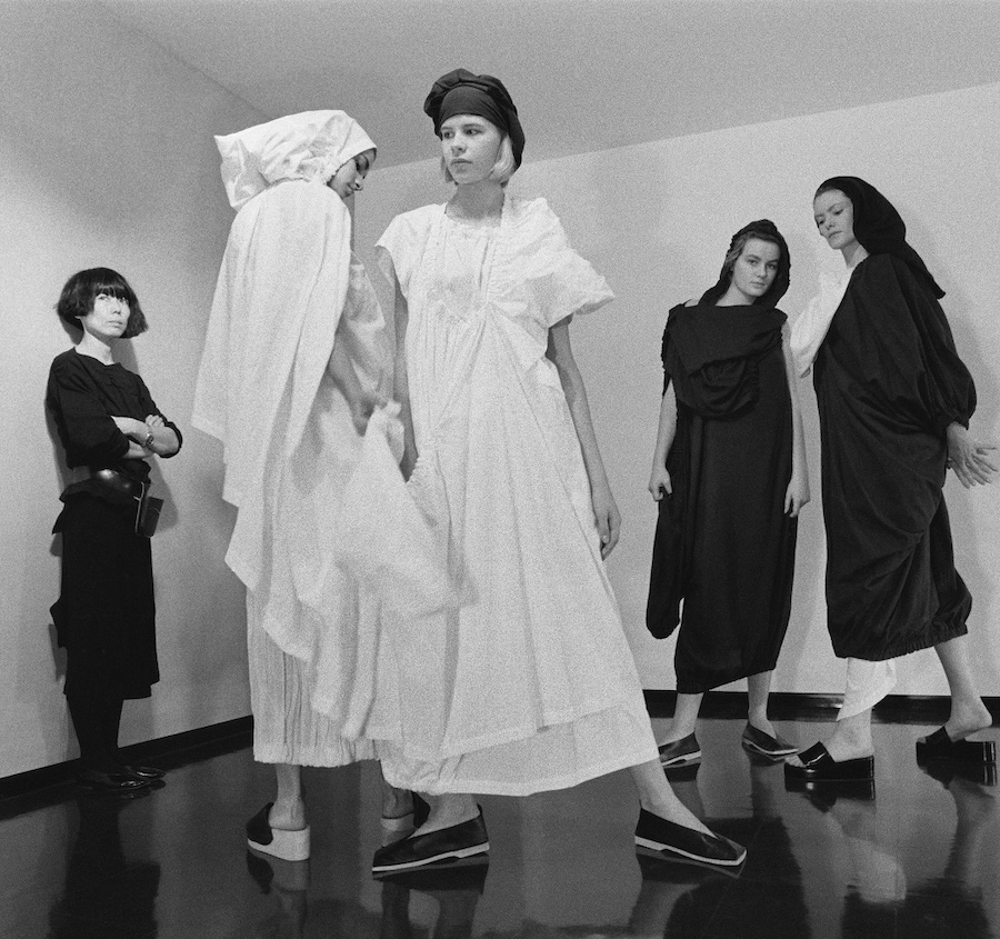 Rei Kawakubo with models wearing Comme des Garçons, published in People, December 26, 1983. Photo by Takeyoshi Tanuma Image courtesy of The Metropolitan Museum of Art